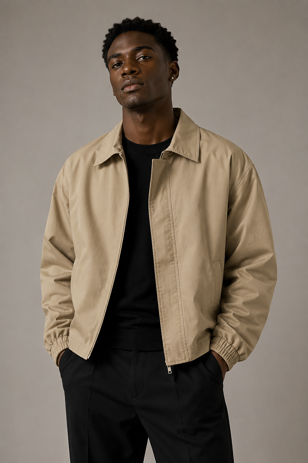 Black male model wearing a khaki lapel zip jacket in a professional studio