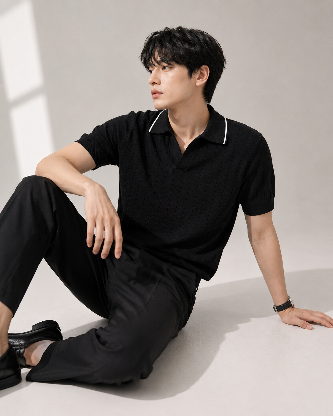 Black ribbed knit polo shirt styled on male model
