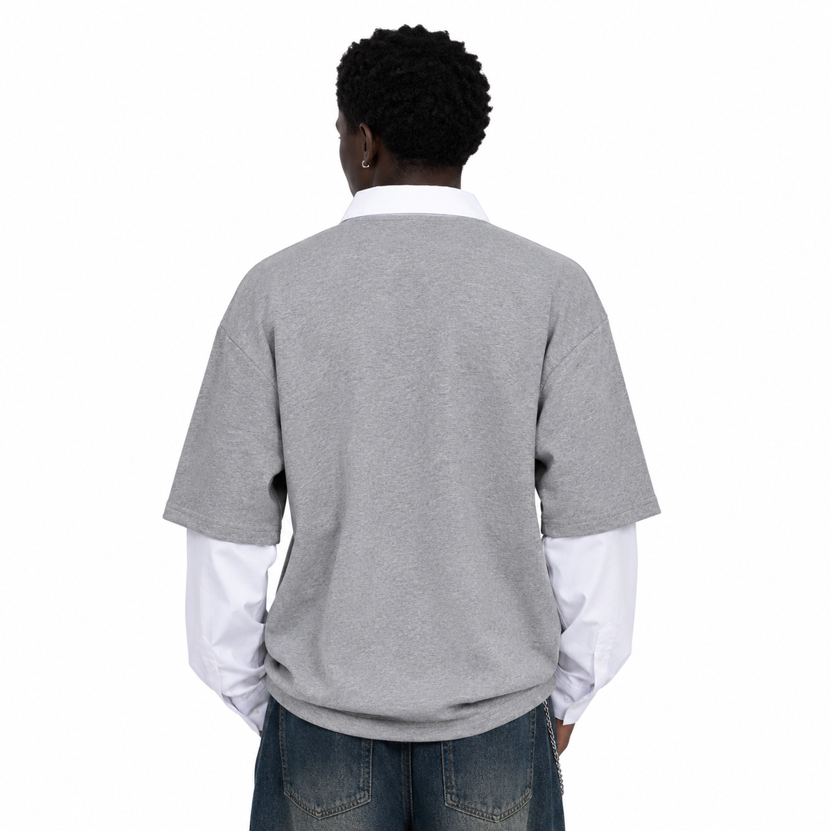Black male model wearing grey retro patchwork long-sleeve polo, back view on white background