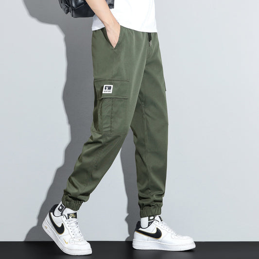 Person wearing green cargo pants with a white background
