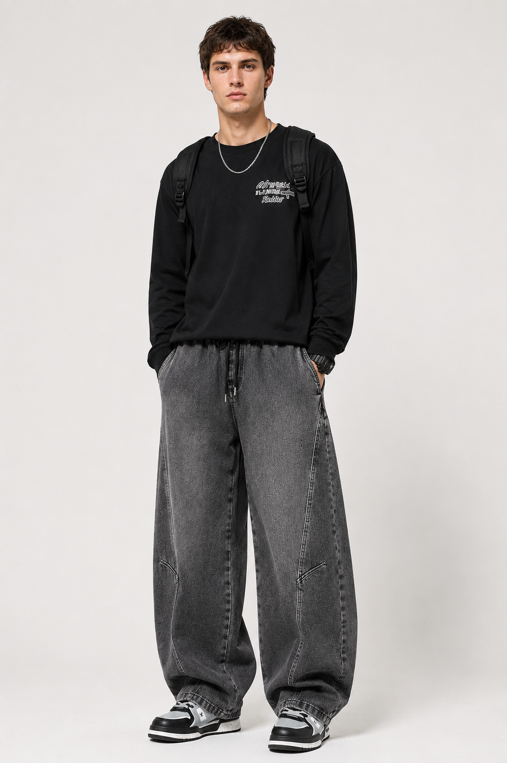Charcoal Axis Utility Trousers styled on a male model in a studio
