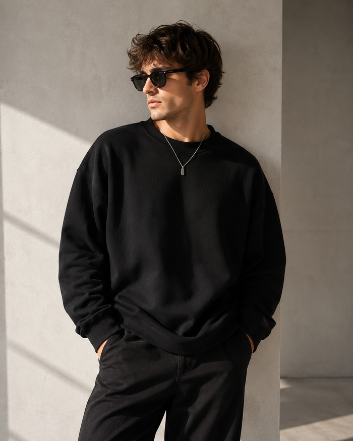 Male model wearing black heavyweight crewneck sweatshirt
