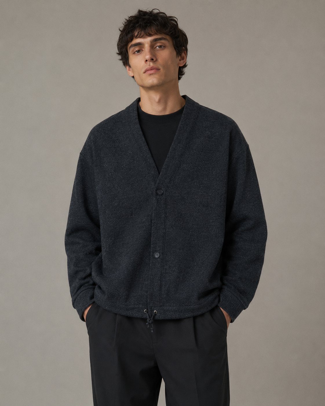 Male model wearing a dark charcoal casual cardigan jacket in a professional studio