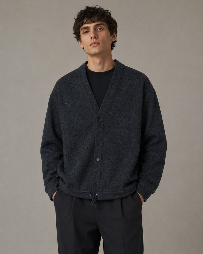 Male model wearing a dark charcoal casual cardigan jacket in a professional studio