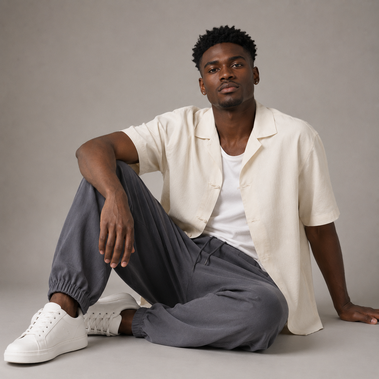 Gray Harbor Tapered Trousers styled on a seated male model