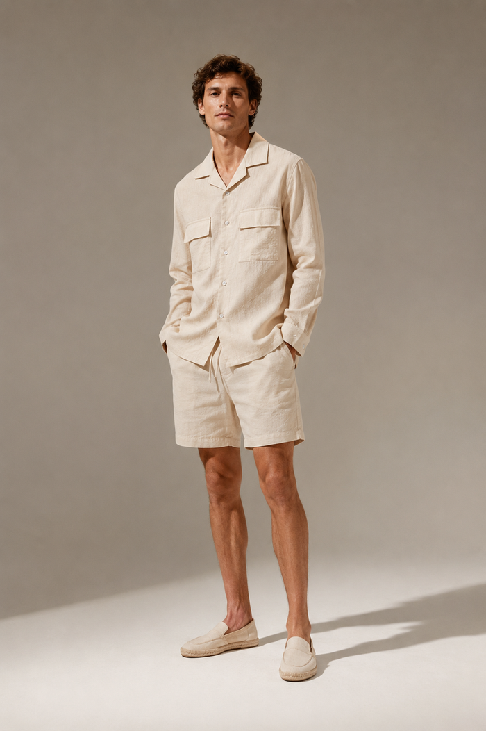 Male model wearing a khaki cotton long-sleeve shirt and matching shorts in a studio
