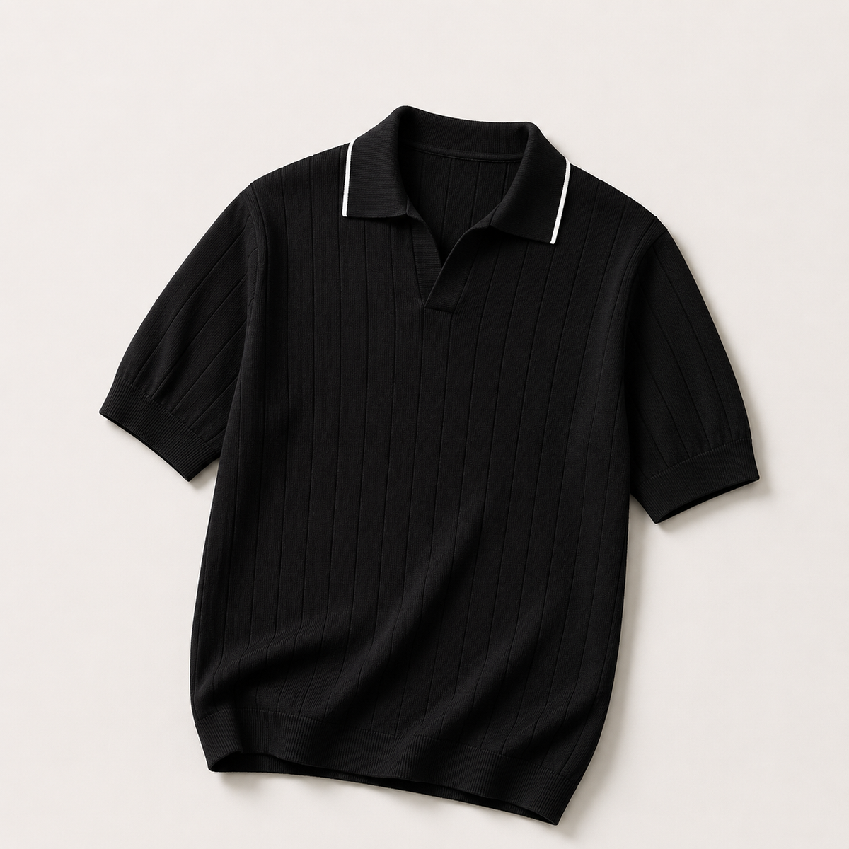 Black ribbed knit polo shirt with white collar piping, flat lay