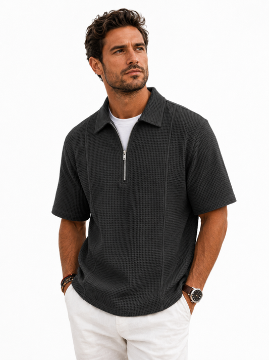 Male model wearing the charcoal Meridian Half-Zip Knit Polo — professional studio photo