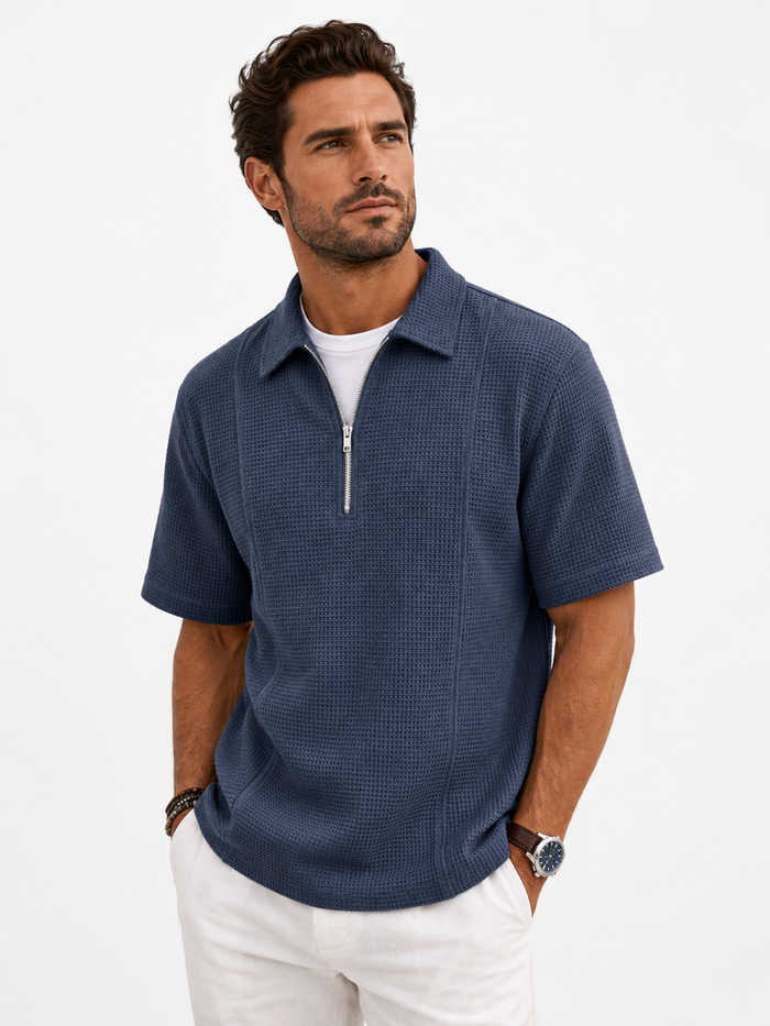 Male model wearing the navy Meridian Half-Zip Knit Polo — professional studio photo