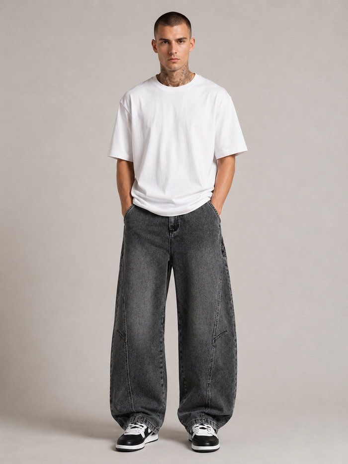 Nikolai Volkov wearing charcoal loose straight-leg utility jeans, front view in a professional studio