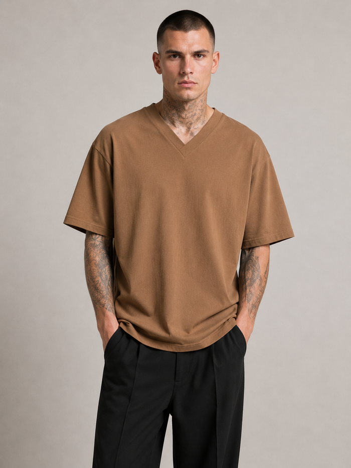 Nikolai Volkov wearing a coffee oversized short-sleeve V-neck T-shirt, front view in a professional studio