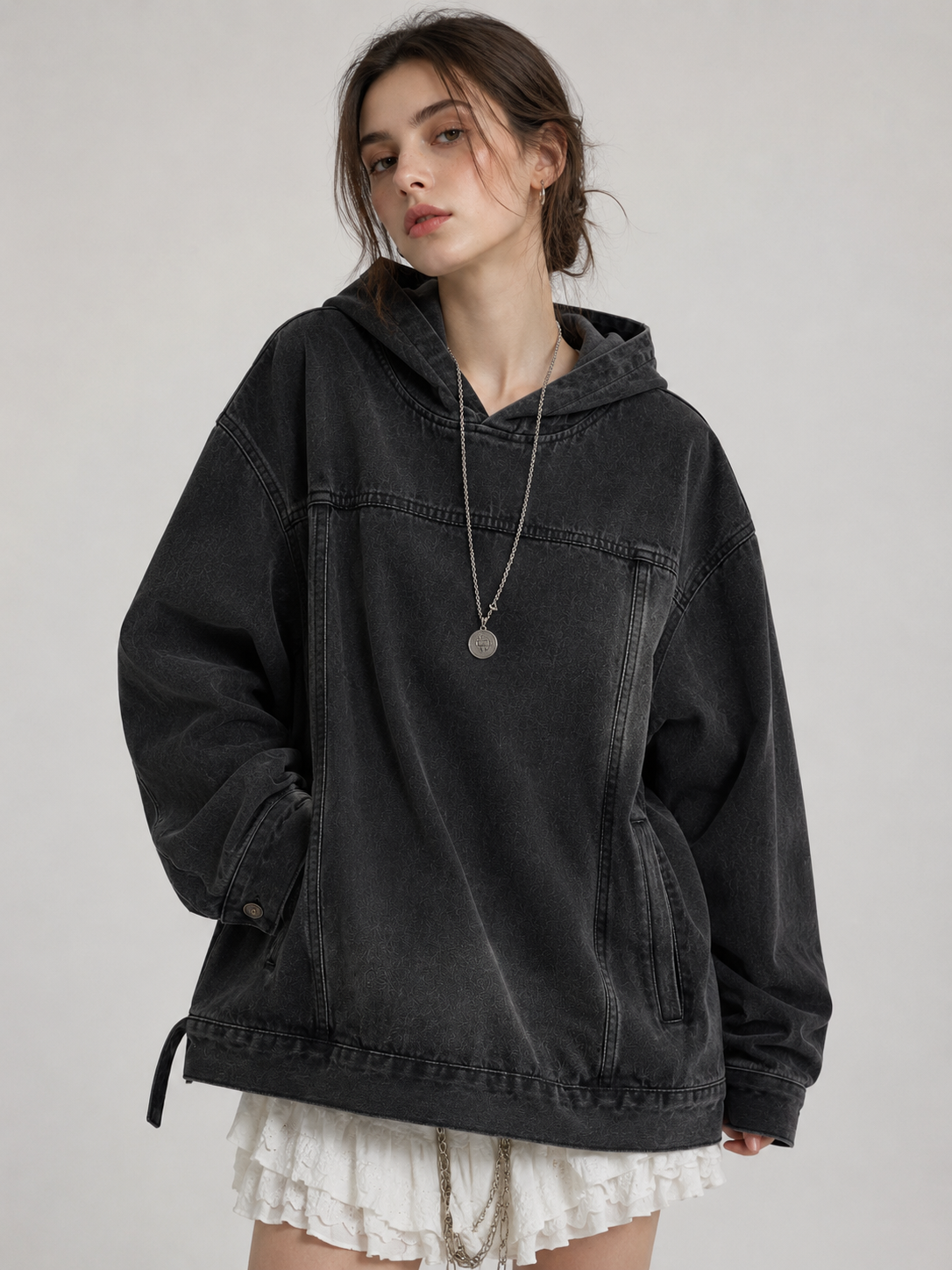 Female model wearing the Nomad Hooded Denim Jacket in black wash