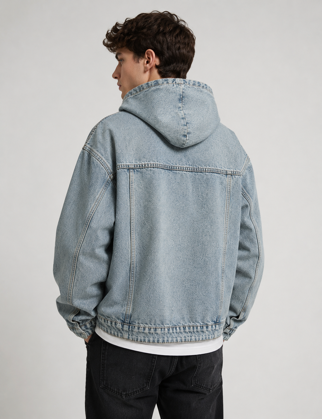 Male model wearing the Nomad Hooded Denim Jacket in vintage blue wash, back view