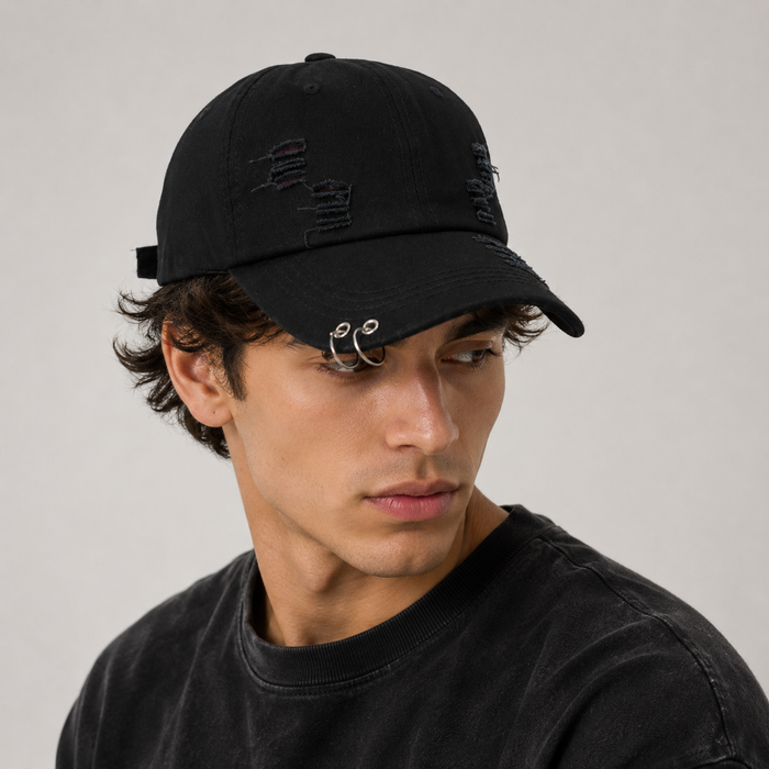 Male model wearing the black Rebel Frayed Denim Cap in a clean studio portrait