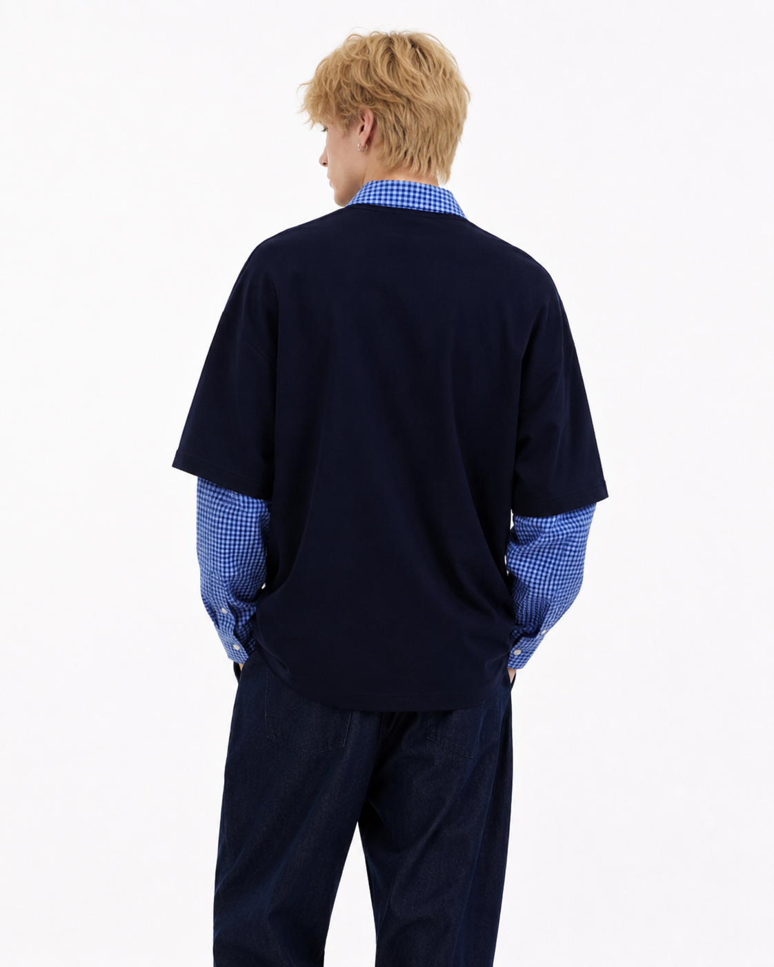 Male model wearing navy retro patchwork long-sleeve polo, back view on white background