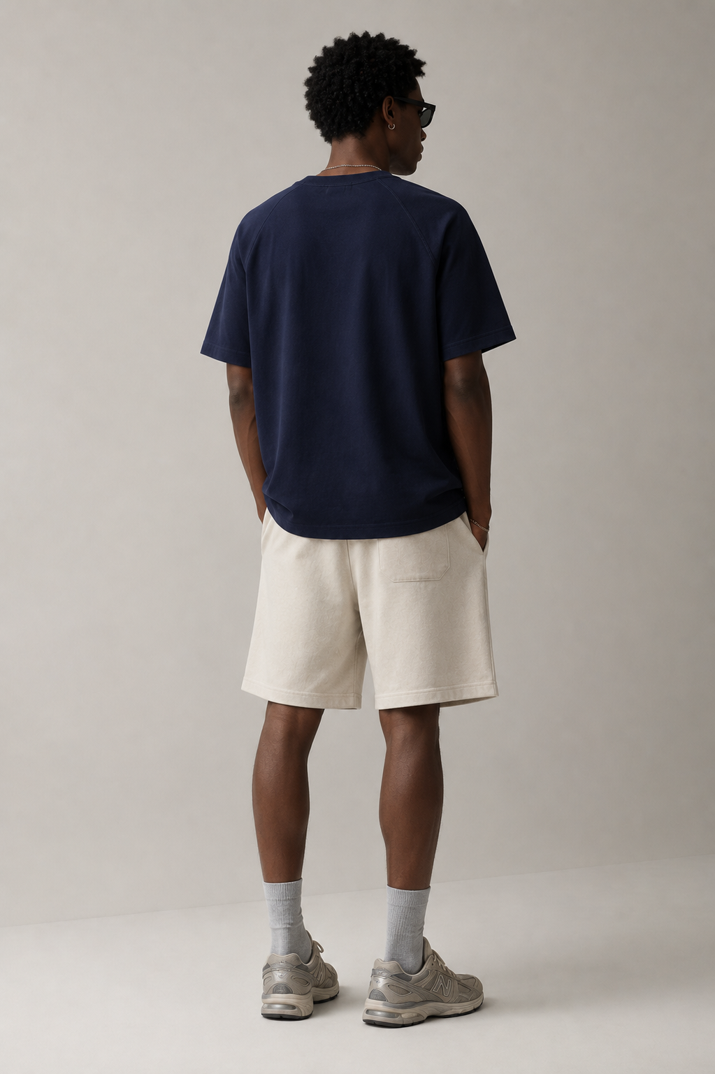 Professional male model wearing the Stitchwork Cotton Tee in sapphire blue — back view