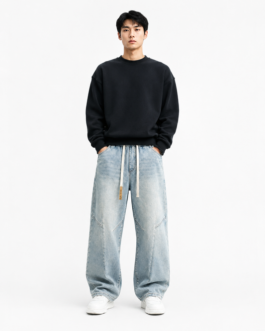 Light blue vintage-washed loose straight-leg jeans worn by a male model on white background