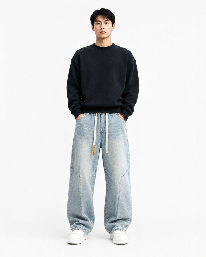Light blue vintage-washed loose straight-leg jeans worn by a male model on white background