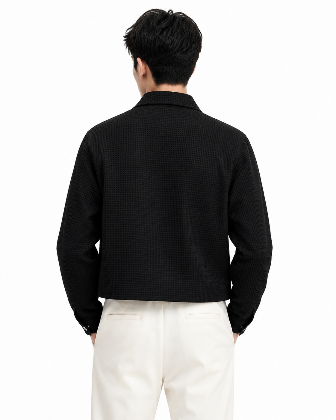 Male model wearing black waffle-knit zip shirt jacket, back view on white background