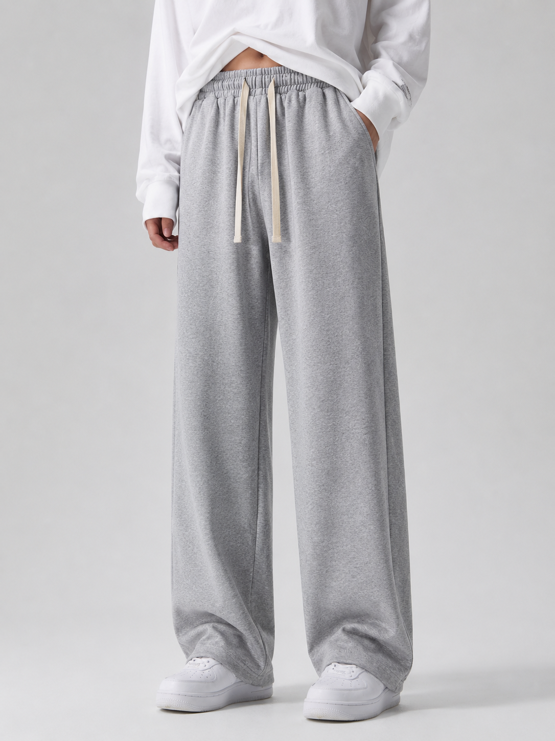 Model wearing light gray wide-leg sweatpants