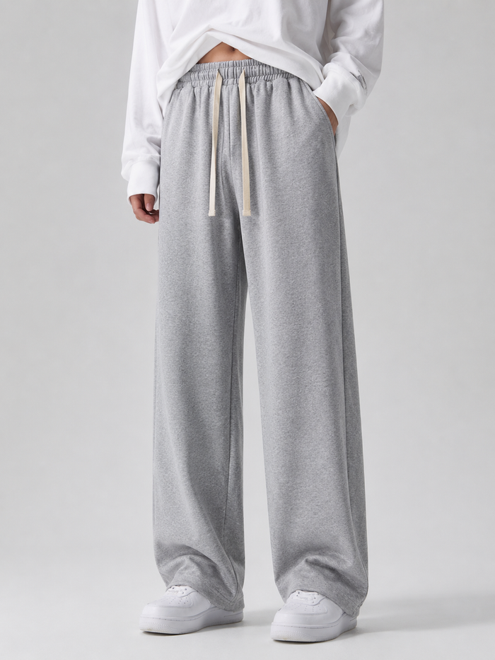 Model wearing light gray wide-leg sweatpants